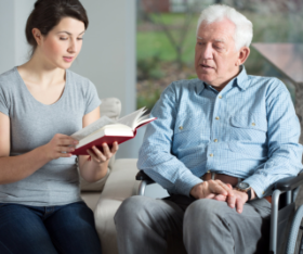 staff reading book with with elder